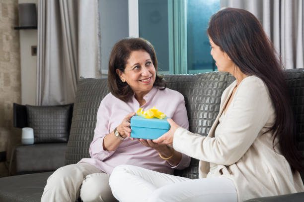 Senior woman and young woman sitting together- Direct Graphix